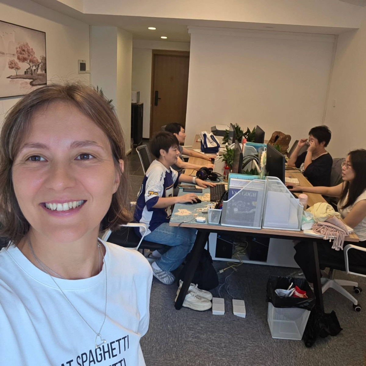 Anna Morozyuk with her sourcing team working at desks in their office