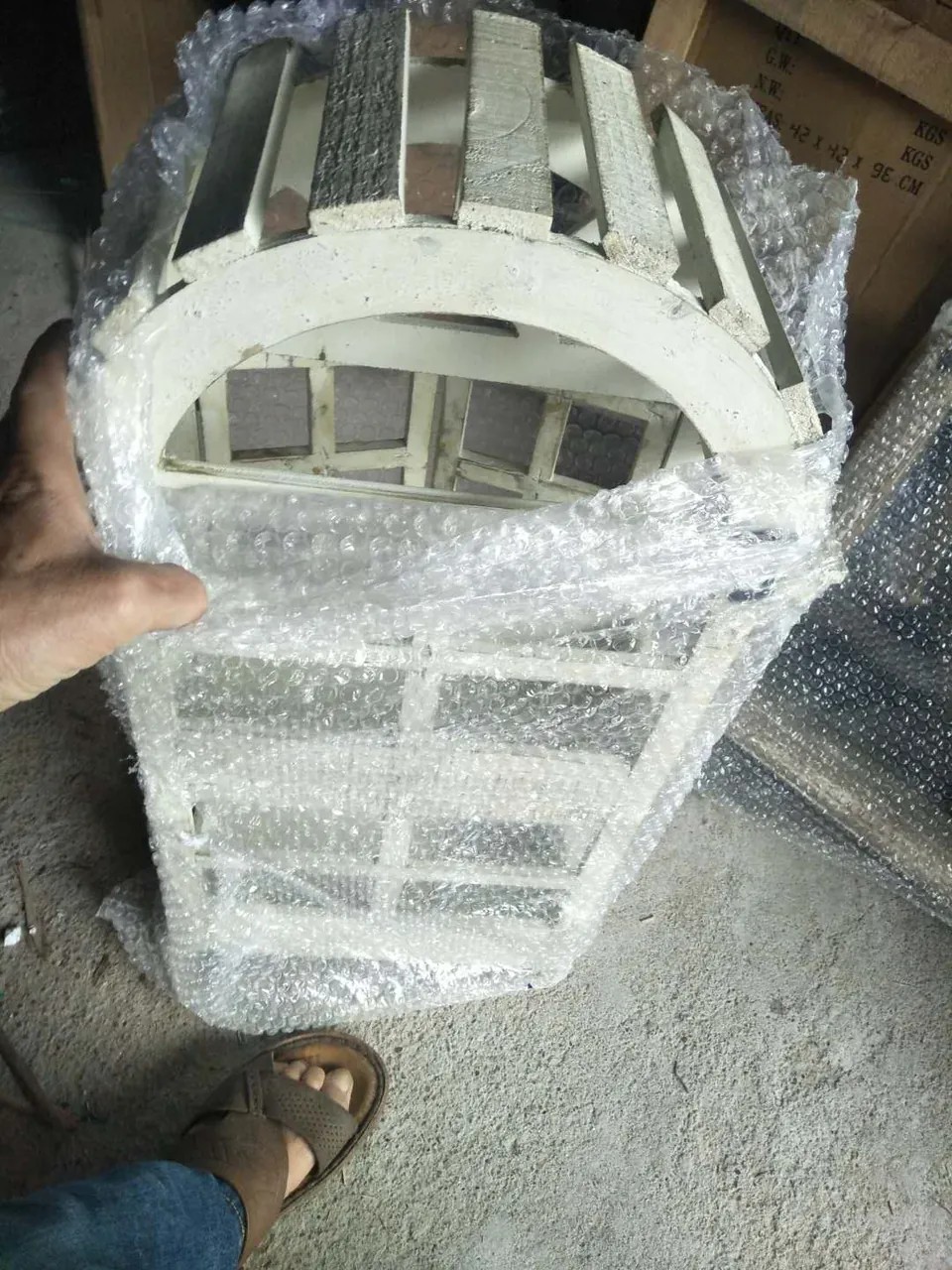 Protective packaging around a furniture component